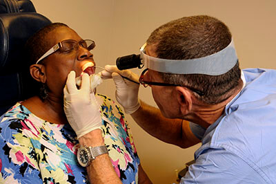 Dr. Alan E. Oshinsky with a patient