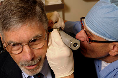 Dr. Alan E. Oshinsky with a patient