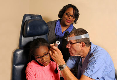 Dr. Alan E. Oshinsky with a pediatric patient