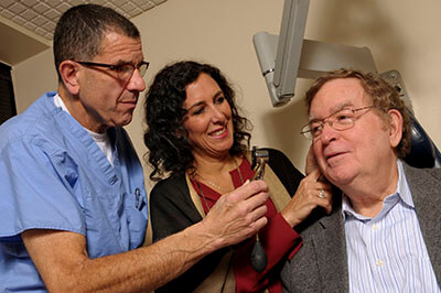 Dr. Alan E. Oshinsky and Rachel A. Raphael with patient