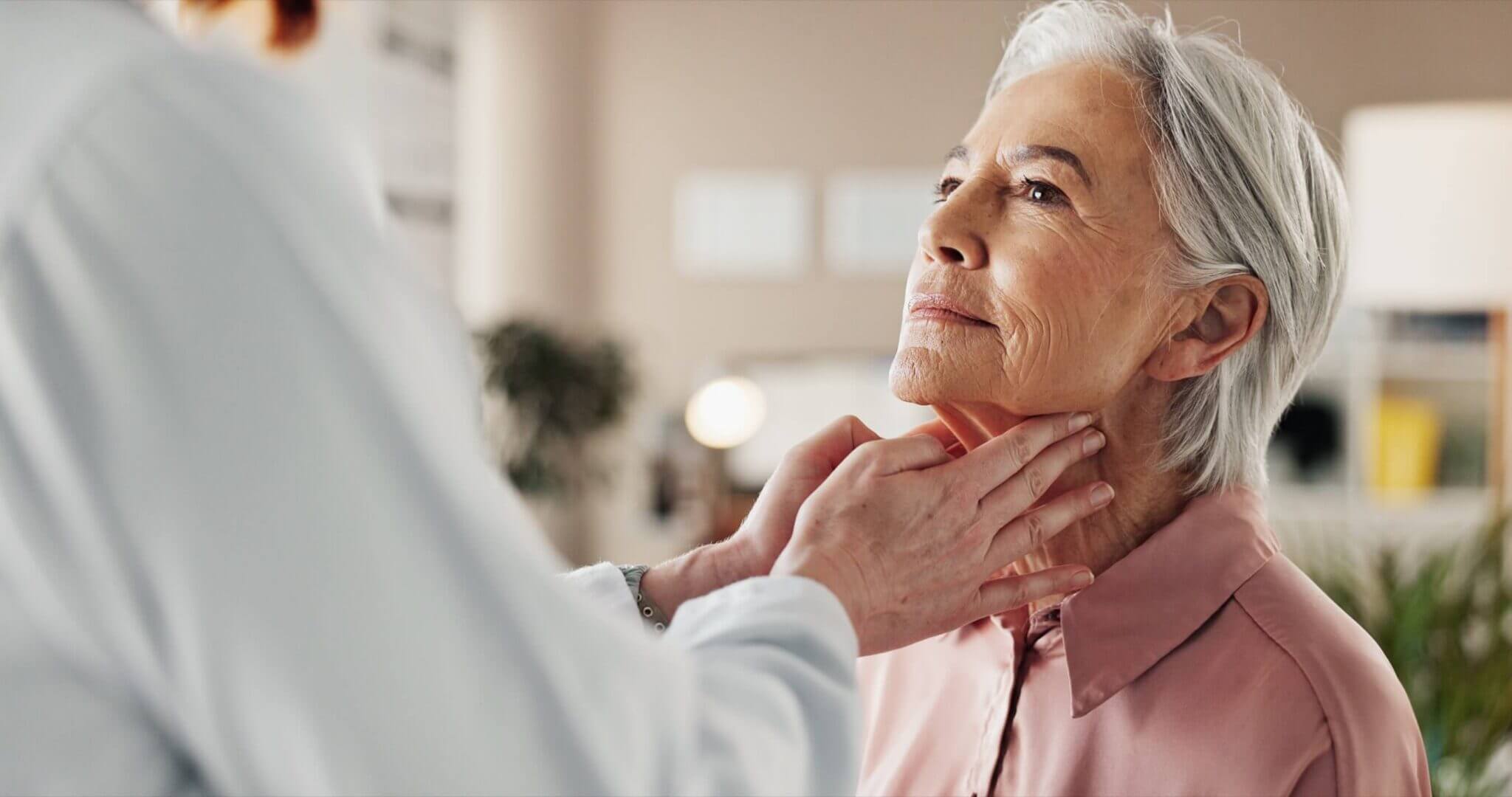 Woman having her neck examined by an ENT doctor