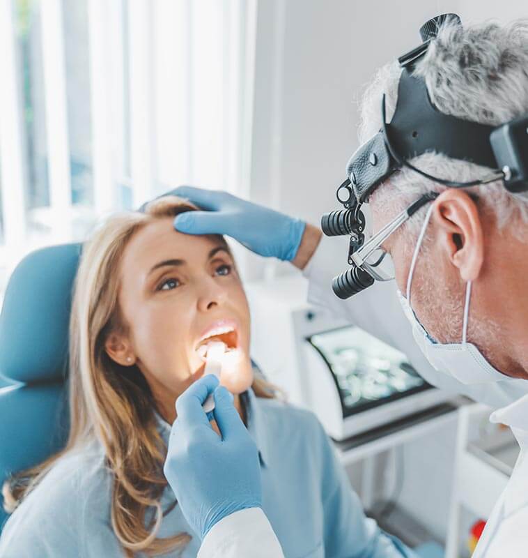 Woman having her throat examined by an ENT