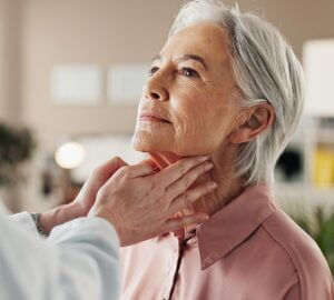 Woman having her neck examined by an ENT doctor