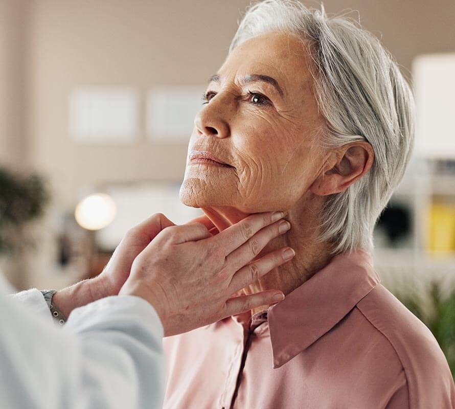 Woman having her neck examined by an ENT doctor
