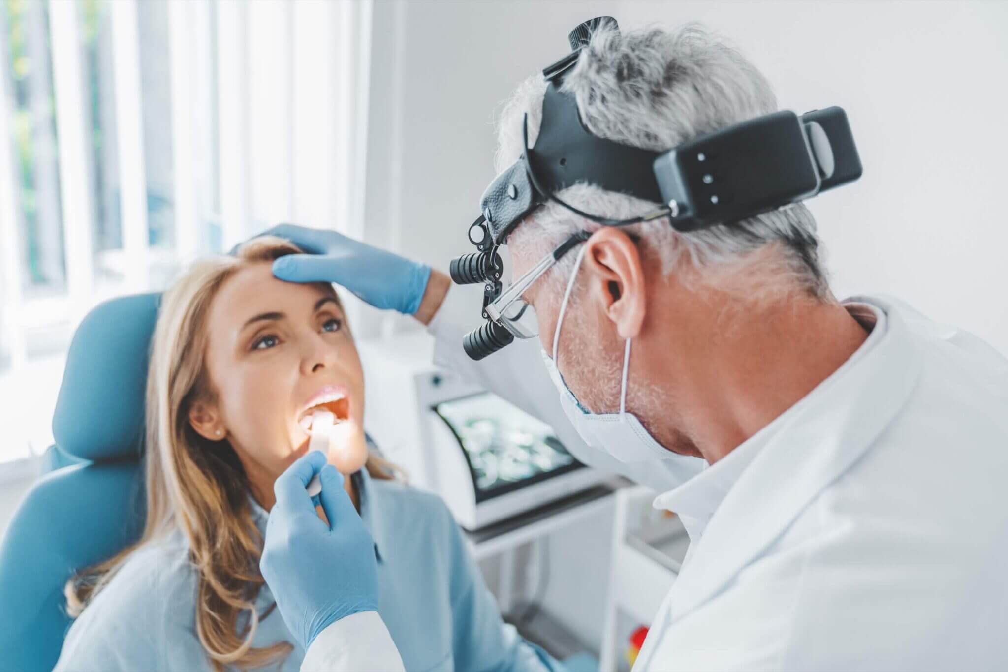 ENT examining woman's throat for disorders